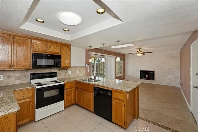 a kitchen with granite countertop a sink stainless steel appliances and cabinets