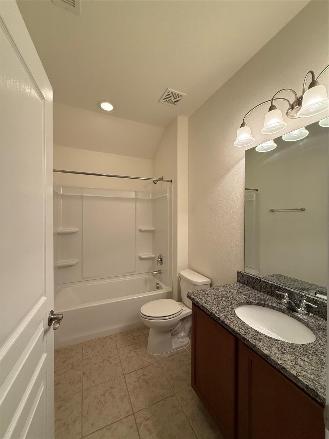22646 Triangle Ridge Drive Porter, TX 77365 - Photo 13 of 17 a bathroom with a granite countertop sink a toilet a mirror and shower