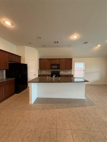 a large kitchen with stainless steel appliances lots of counter top space