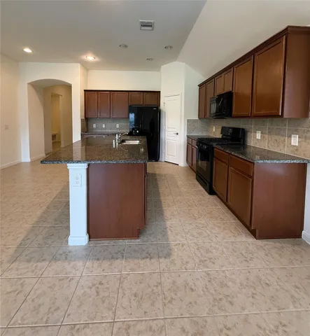 a view of a kitchen with a sink and a window