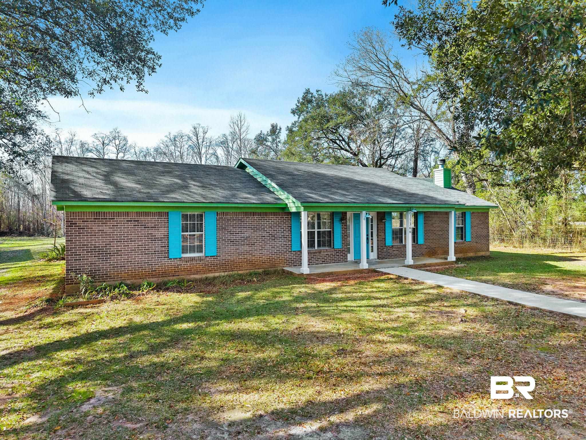 17366 Old Brady Road Bay Minette, AL 36507 - Photo 36 of 43 Ranch-style home featuring brick siding, covered porch, a chimney, a shingled roof, and a front yard