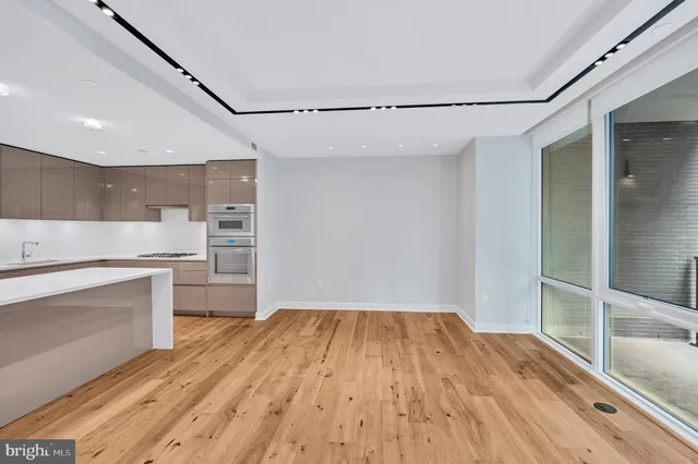 a kitchen with a wooden floor and white appliances