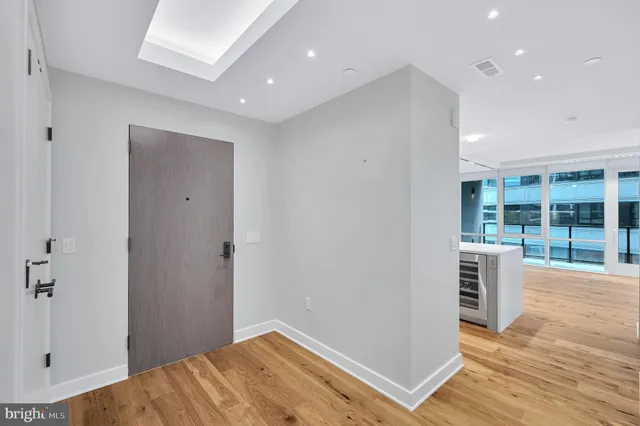 a view of hallway with wooden floor and windows
