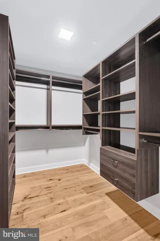 a view of walk in closet with empty racks