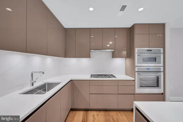a kitchen with a sink stove and cabinets