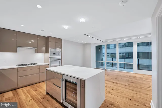 a kitchen with a stove a sink dishwasher and a refrigerator