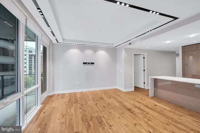 a view of empty room with wooden floor