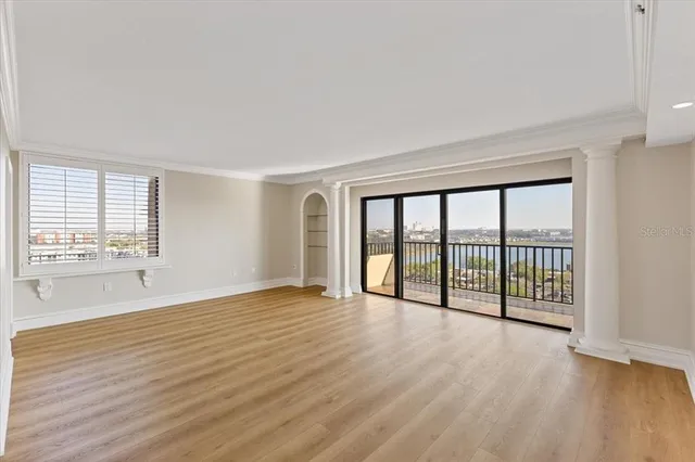 wooden floor in an empty room with a window