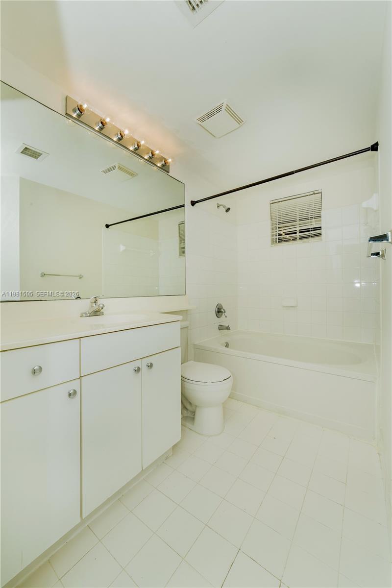 17145 North Bay Road, Unit 4203 Sunny Isles Beach, FL 33160 - Photo 13 of 50 a spacious bathroom with a double vanity sink toilet and shower