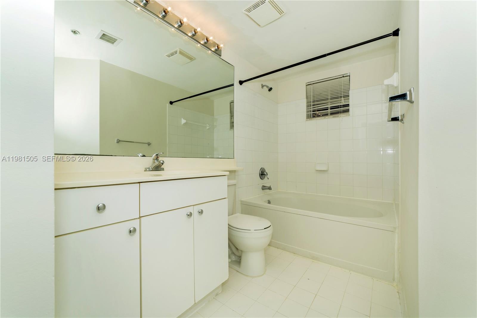 17145 North Bay Road, Unit 4203 Sunny Isles Beach, FL 33160 - Photo 14 of 50 a bathroom with a double vanity sink toilet mirror and shower