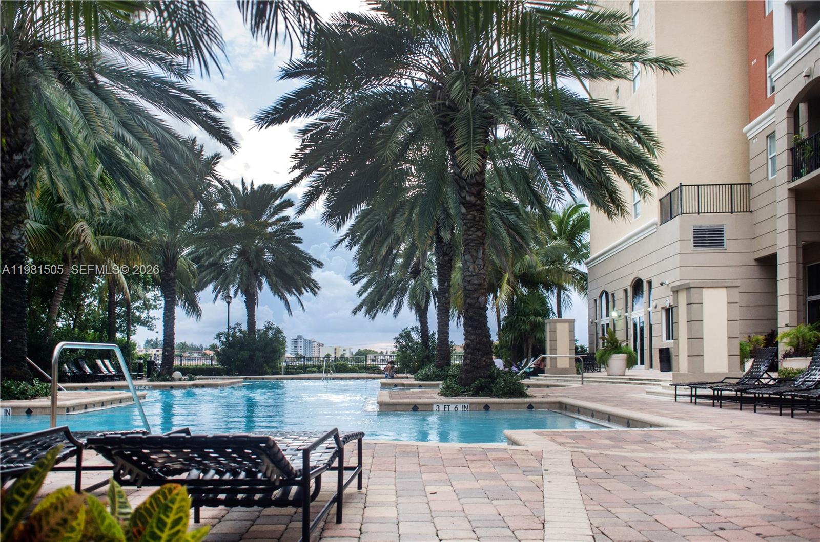 17145 North Bay Road, Unit 4203 Sunny Isles Beach, FL 33160 - Photo 30 of 50 a view of a swimming pool with a table and chairs
