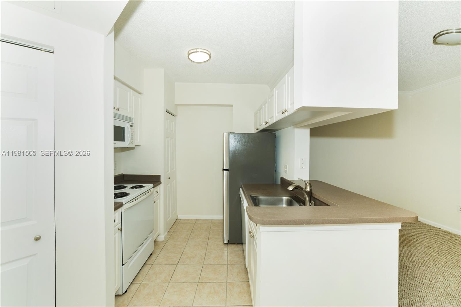 17145 North Bay Road, Unit 4203 Sunny Isles Beach, FL 33160 - Photo 7 of 50 a kitchen with stainless steel appliances granite countertop a sink stove and refrigerator