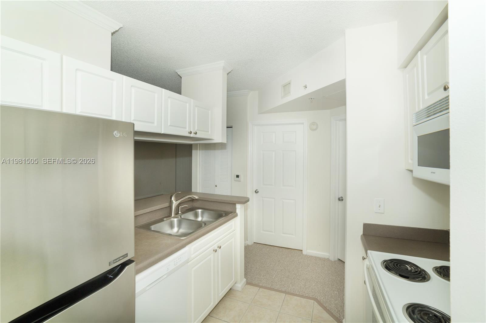 17145 North Bay Road, Unit 4203 Sunny Isles Beach, FL 33160 - Photo 10 of 50 a kitchen with a sink and cabinets
