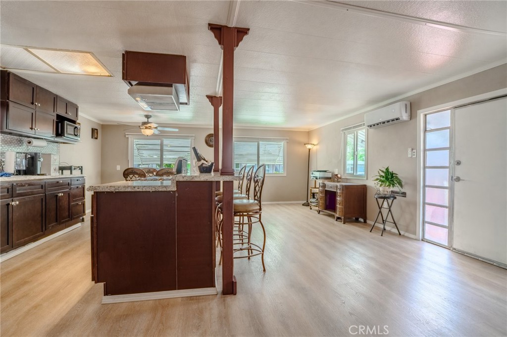 9340 Foothill Boulevard, Unit 68 Rancho Cucamonga, CA 91730 - Photo 9 of 30 a living room with furniture wooden floor and a kitchen view