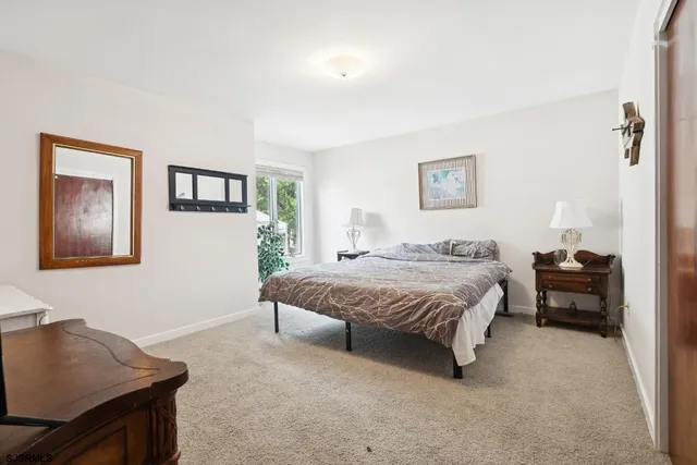 a spacious bedroom with a bed and a desk