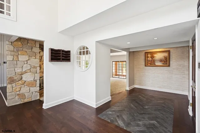 an empty room with windows and cabinet