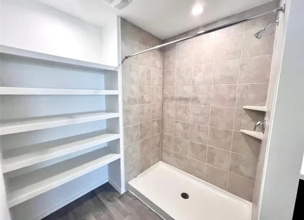 a bathroom with a bathtub and shower