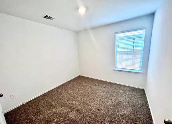 an empty room with a empty space and a window