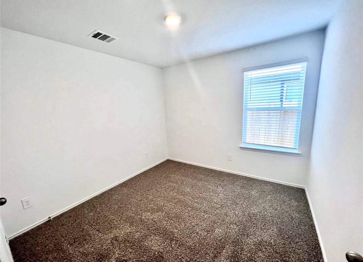 14220 Fern Meadows Drive Splendora, TX 77372 - Photo 17 of 22 an empty room with a empty space and a window