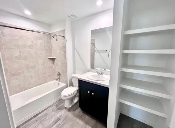a bathroom with a double vanity sink toilet and shower