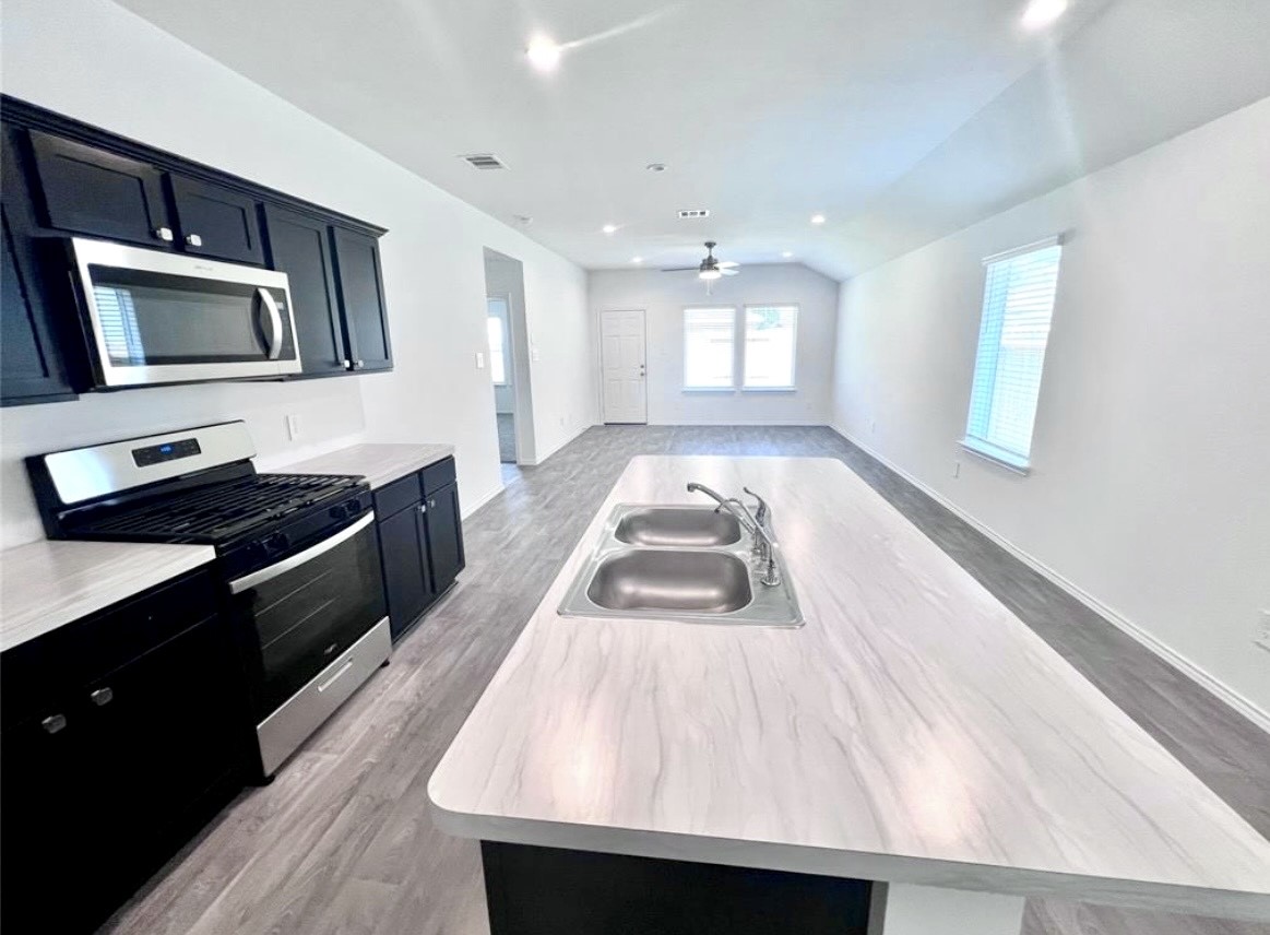 14220 Fern Meadows Drive Splendora, TX 77372 - Photo 8 of 22 a kitchen with a sink and large window
