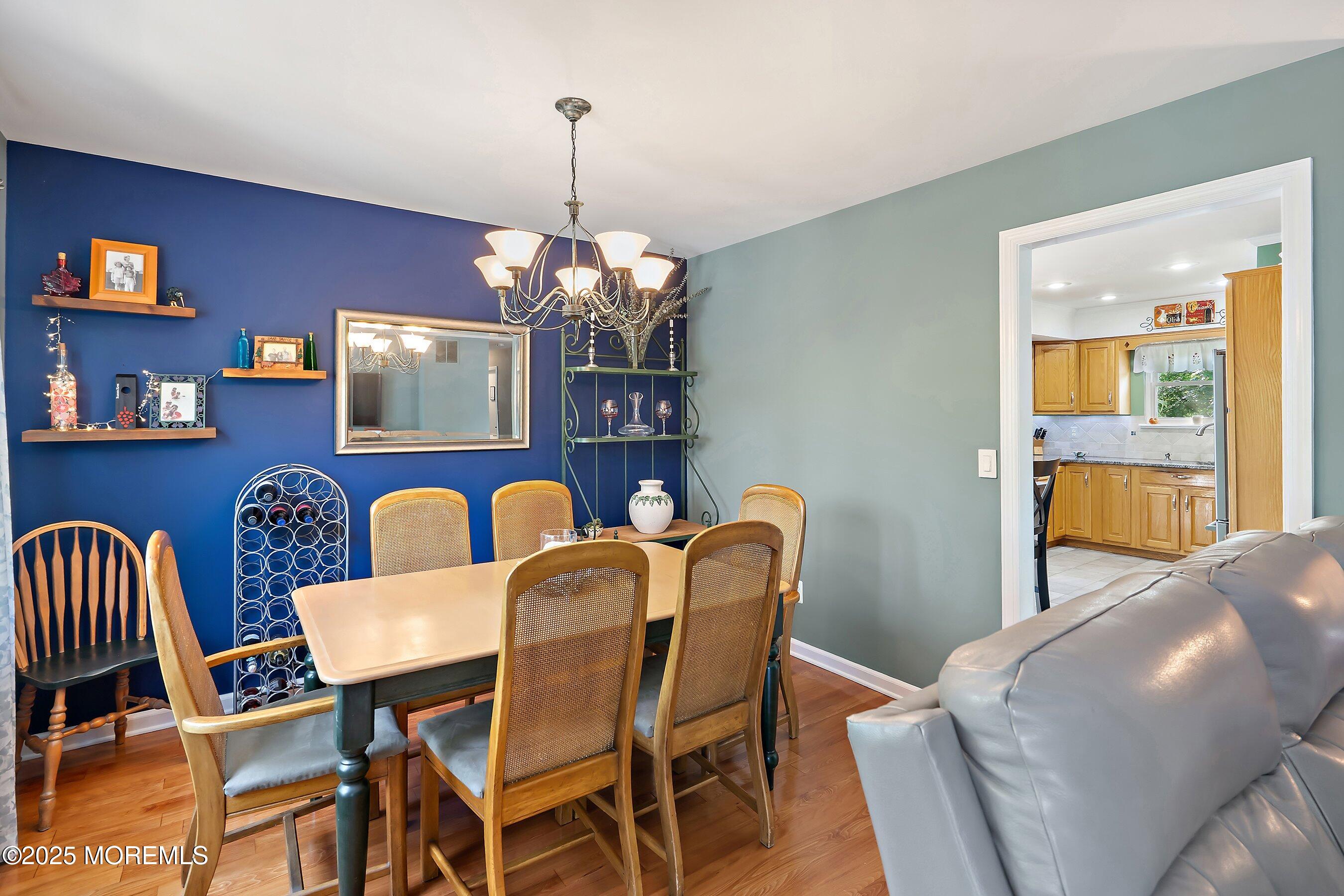 10 Cove Court Howell, NJ 07731 - Photo 12 of 40 a view of a dining room with furniture a chandelier and wooden floor