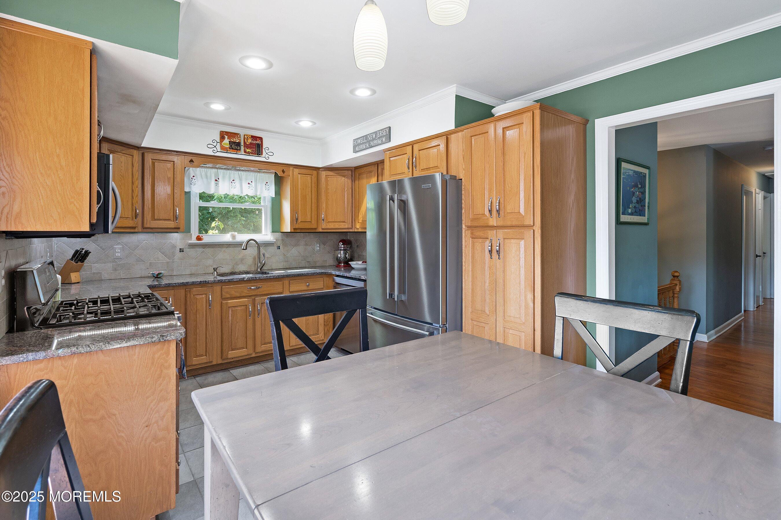 10 Cove Court Howell, NJ 07731 - Photo 14 of 40 a kitchen with stainless steel appliances granite countertop a stove a sink a refrigerator and island