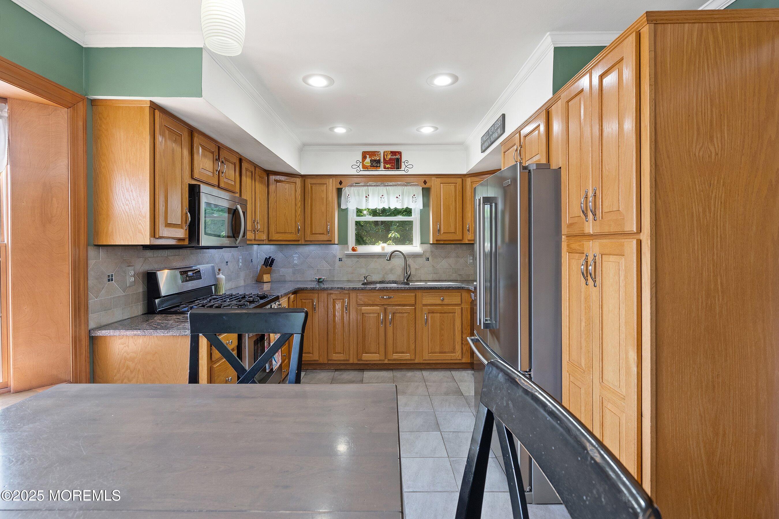 10 Cove Court Howell, NJ 07731 - Photo 17 of 40 a kitchen with stainless steel appliances granite countertop a refrigerator and a stove top oven