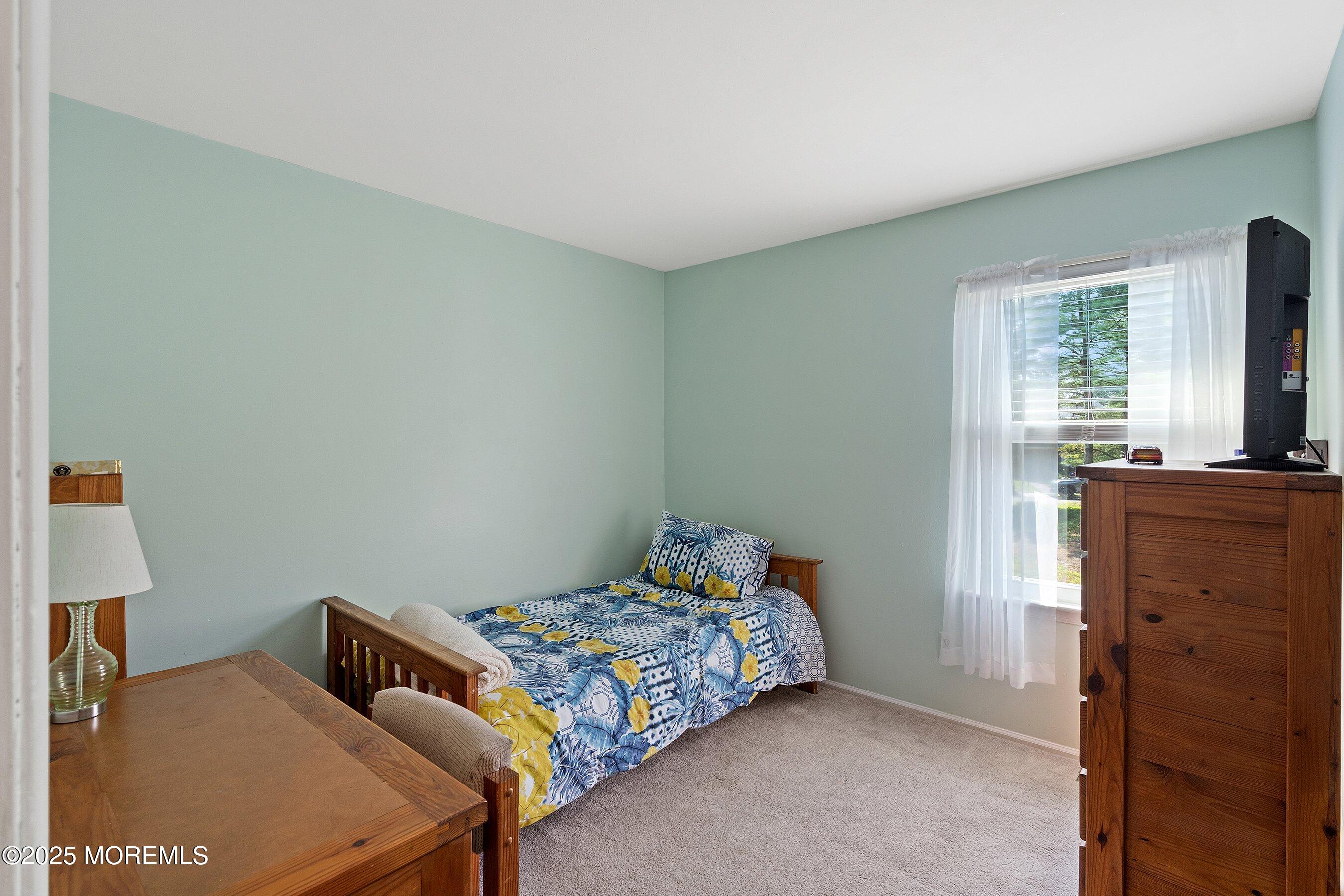 10 Cove Court Howell, NJ 07731 - Photo 21 of 40 a bedroom with a bed and wooden floor