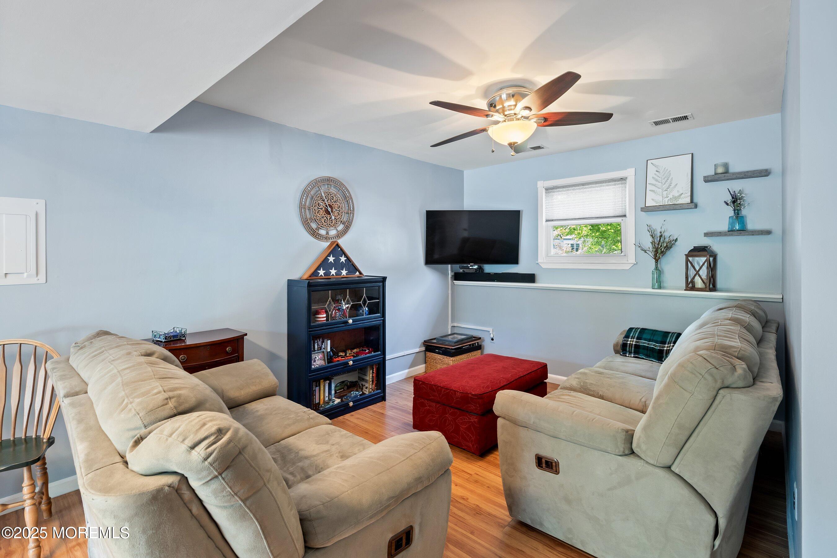 10 Cove Court Howell, NJ 07731 - Photo 30 of 40 a living room with furniture a window and a flat screen tv