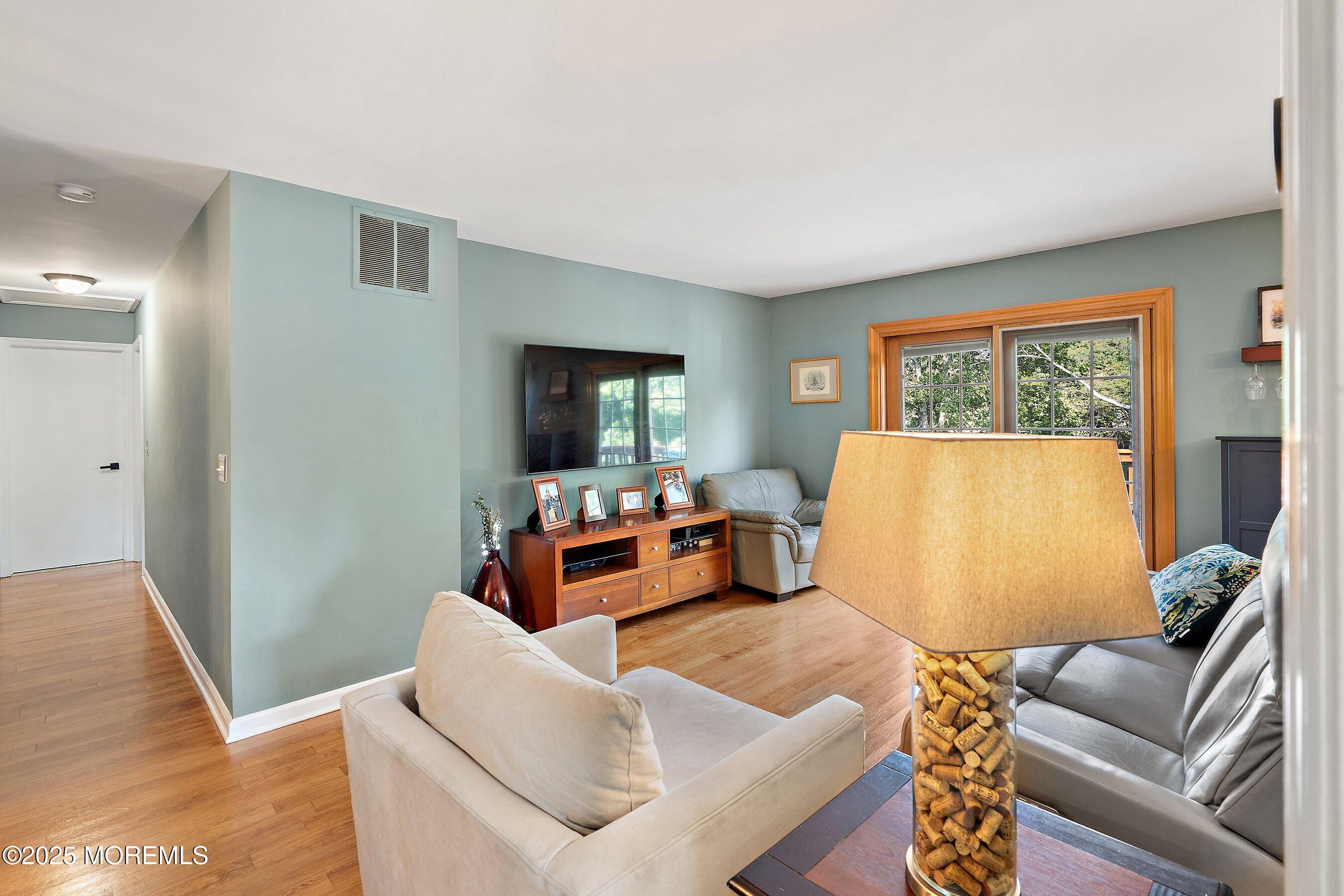 10 Cove Court Howell, NJ 07731 - Photo 8 of 40 a living room with furniture and a flat screen tv