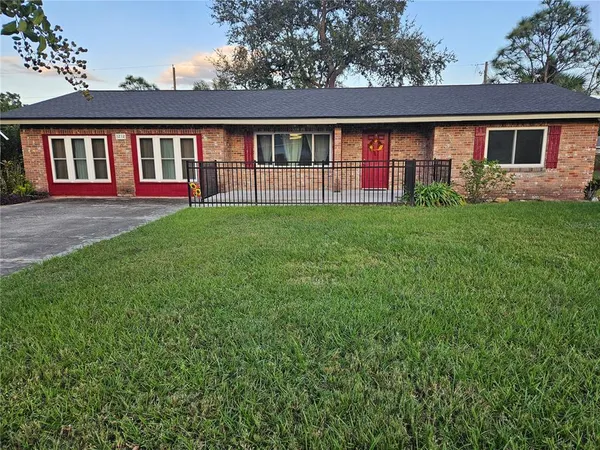 a front view of house with yard and green space