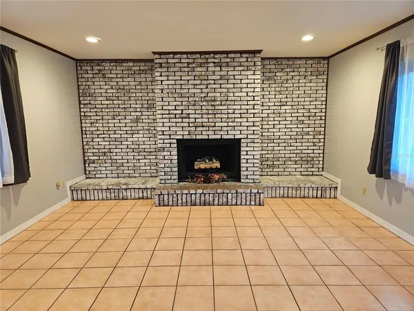 a view of an empty room and fire place