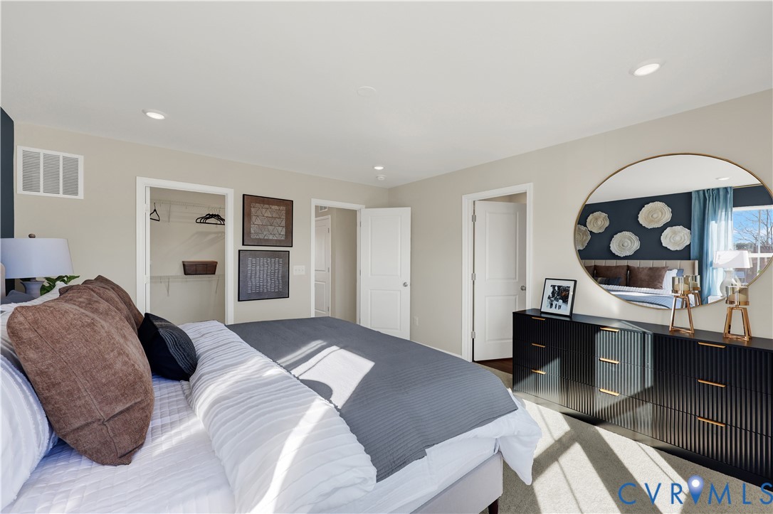 6117 Primrose Path Road Richmond, VA 23225 - Photo 18 of 27 a bedroom with a bed and a table