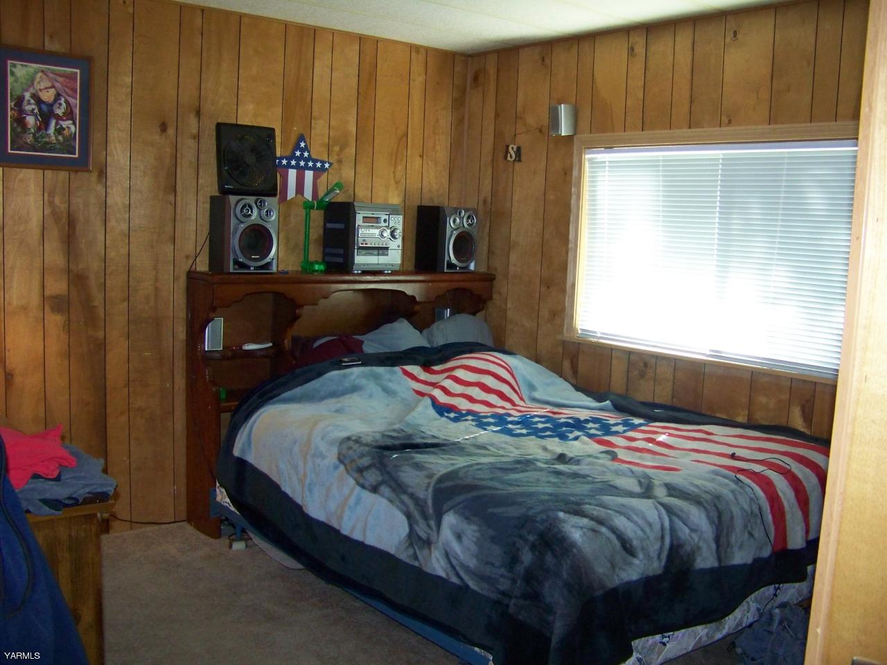 2607 Beaudry Road Yakima, WA 98901 - Photo 14 of 28 a bedroom with a bed and a window