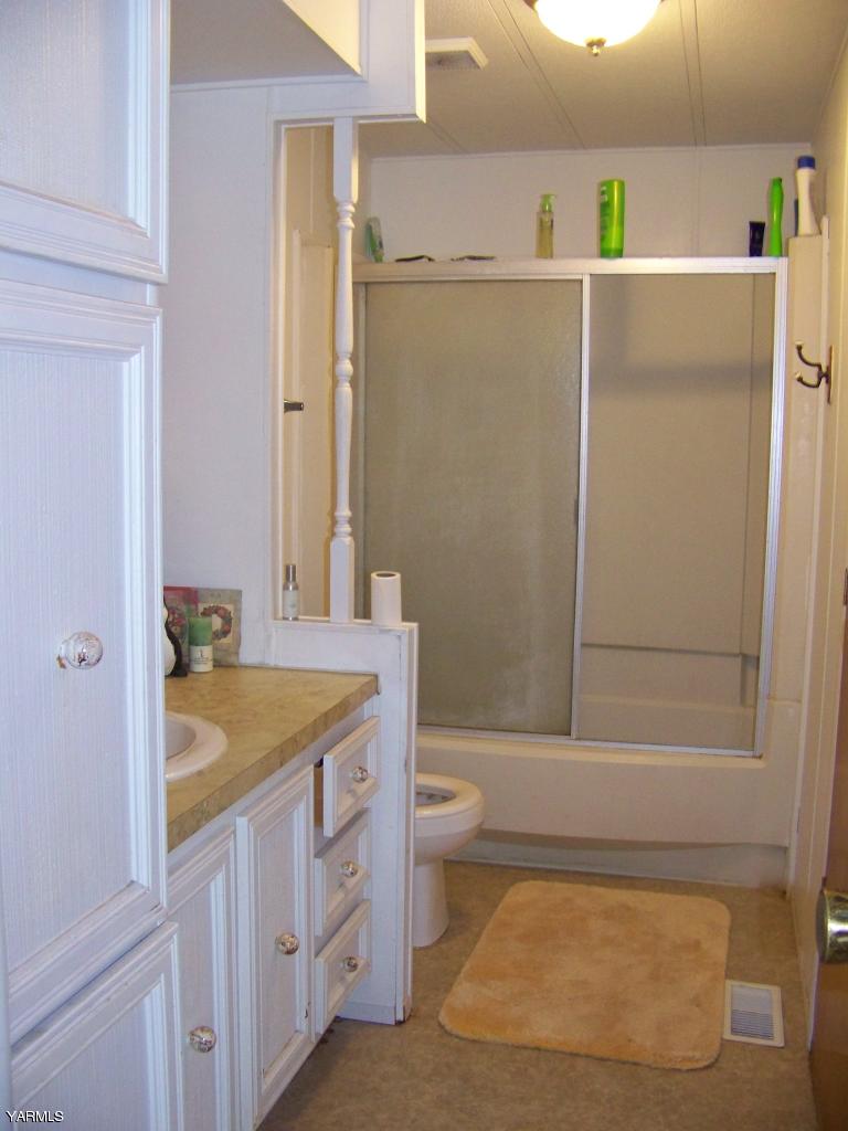 2607 Beaudry Road Yakima, WA 98901 - Photo 18 of 28 a bathroom with a granite countertop sink mirror and toilet