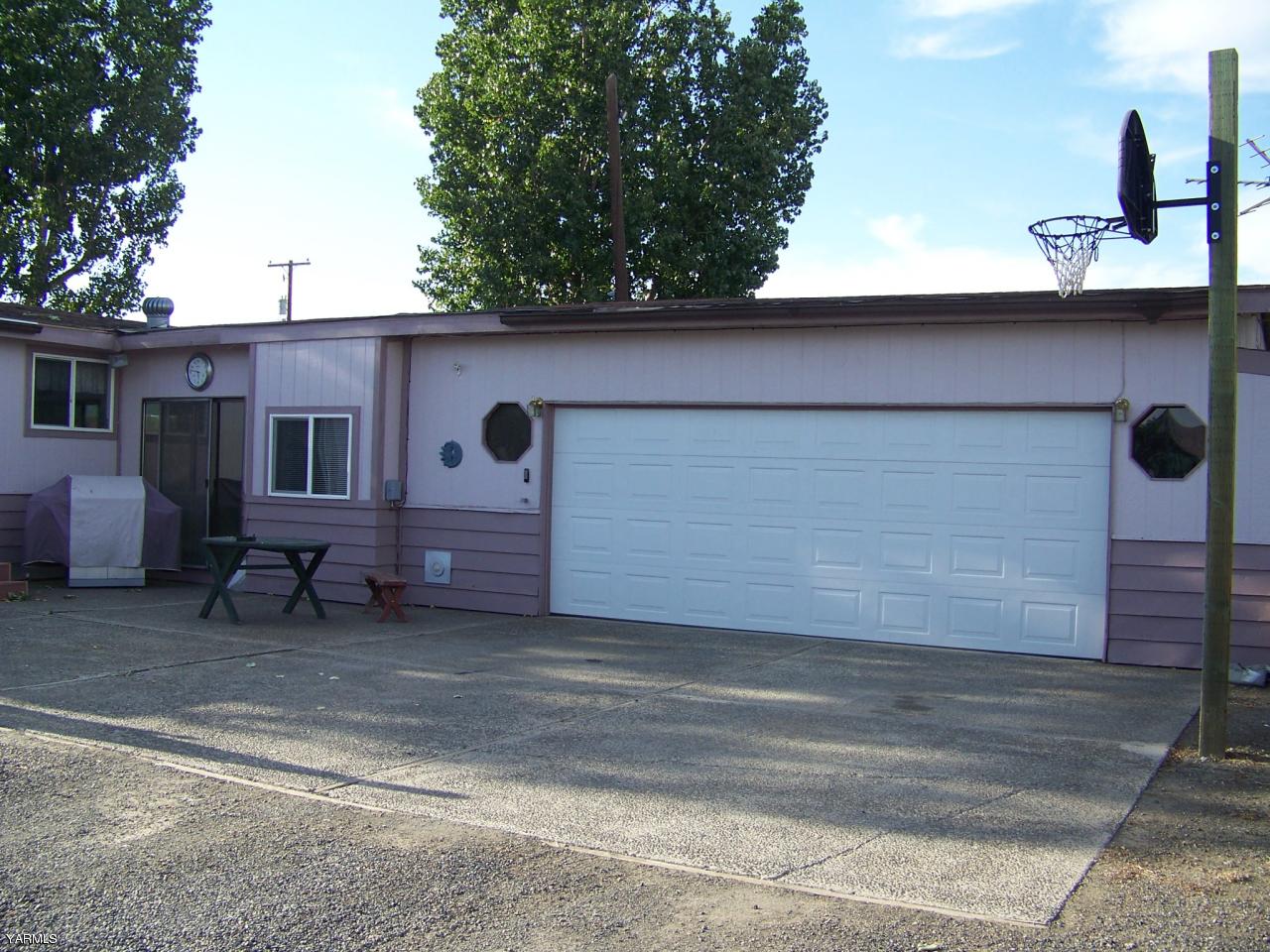 2607 Beaudry Road Yakima, WA 98901 - Photo 24 of 28 a backyard of a house with large trees and barbeque oven