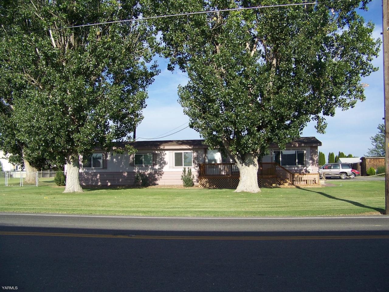 2607 Beaudry Road Yakima, WA 98901 - Photo 27 of 28 a view of a house with a big yard and large trees