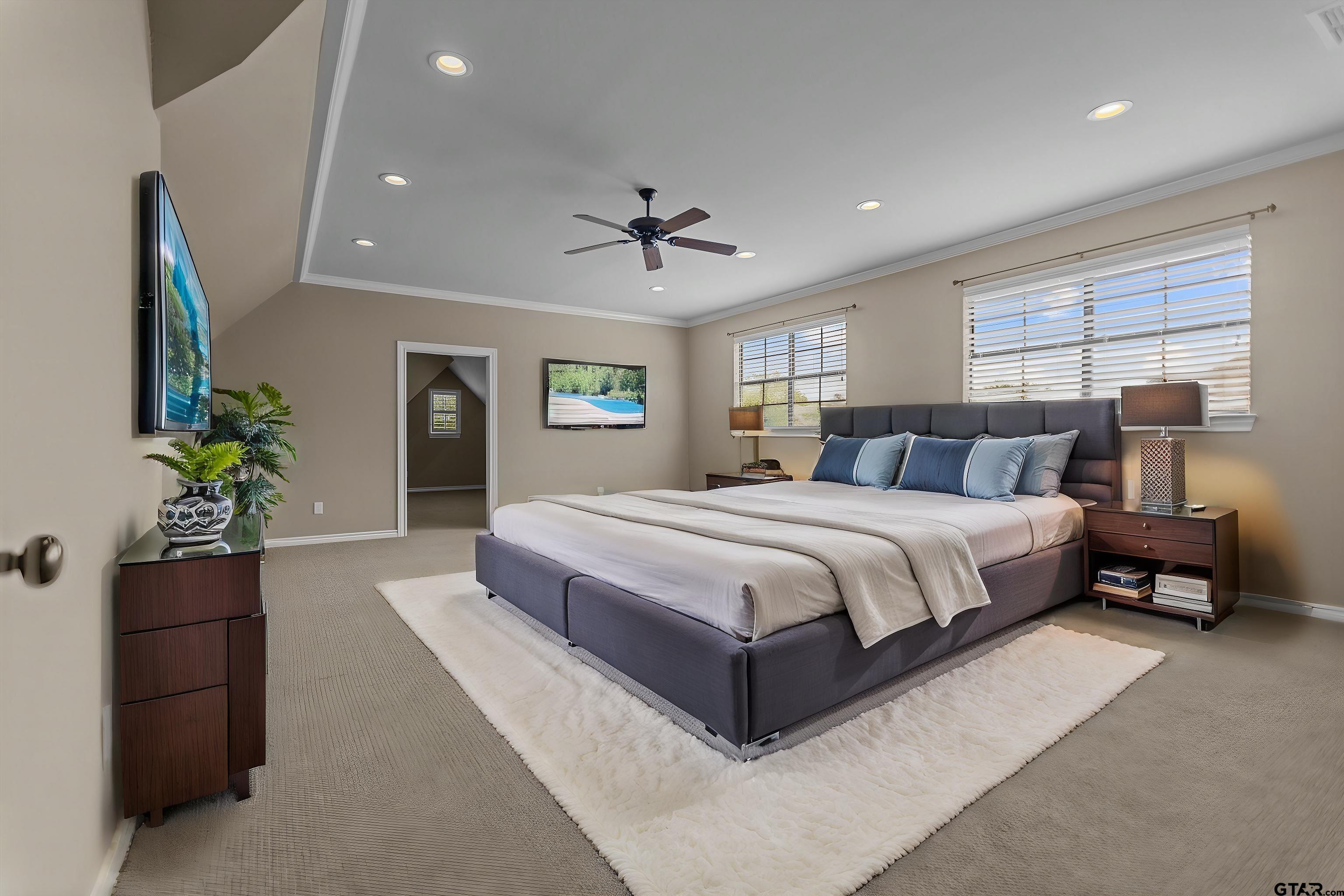 2312 Pinehurst Street Tyler, TX 75703 - Photo 11 of 43 a bedroom with a large bed and a potted plant