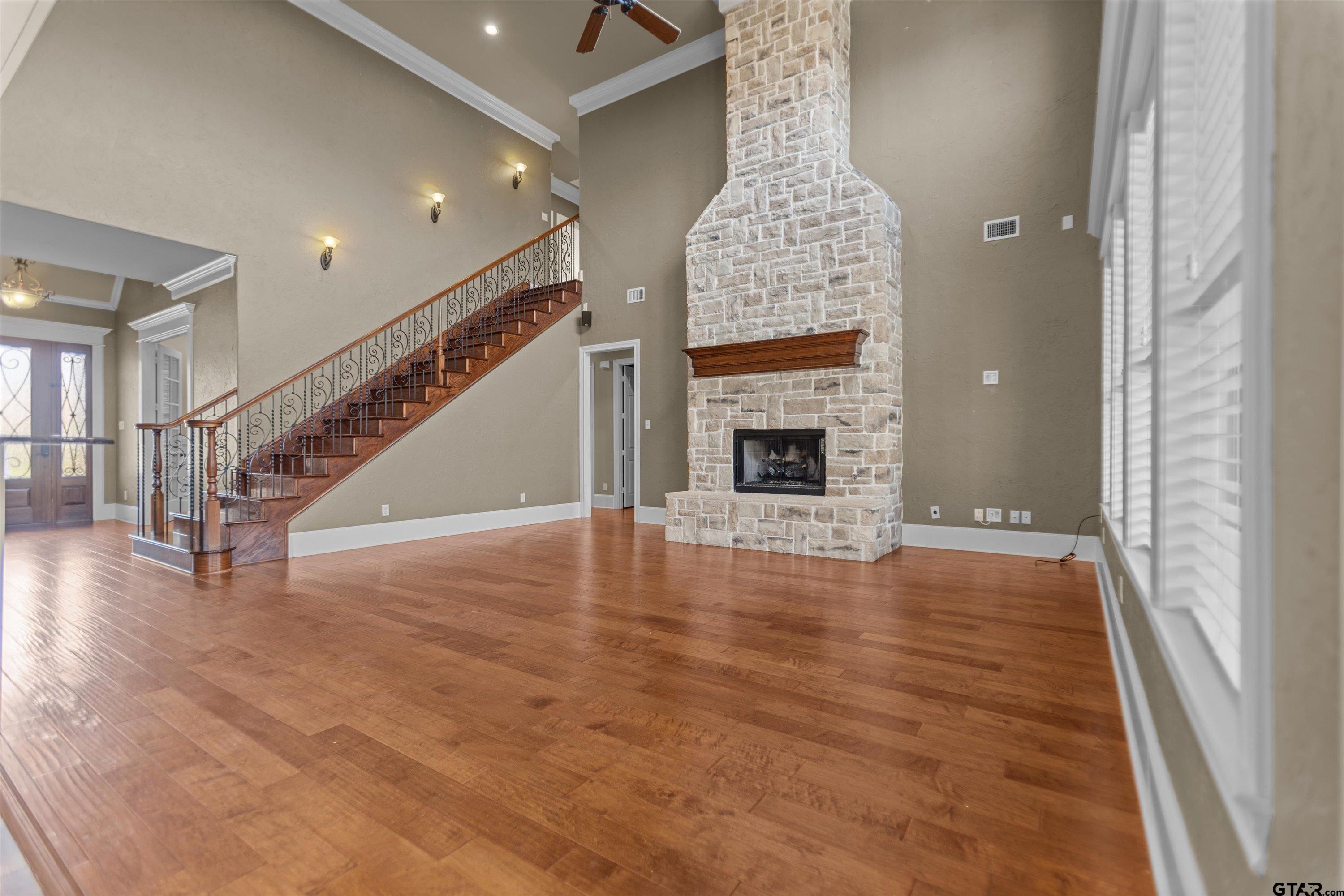 2312 Pinehurst Street Tyler, TX 75703 - Photo 18 of 43 a view of an empty room with wooden floor fireplace and a window