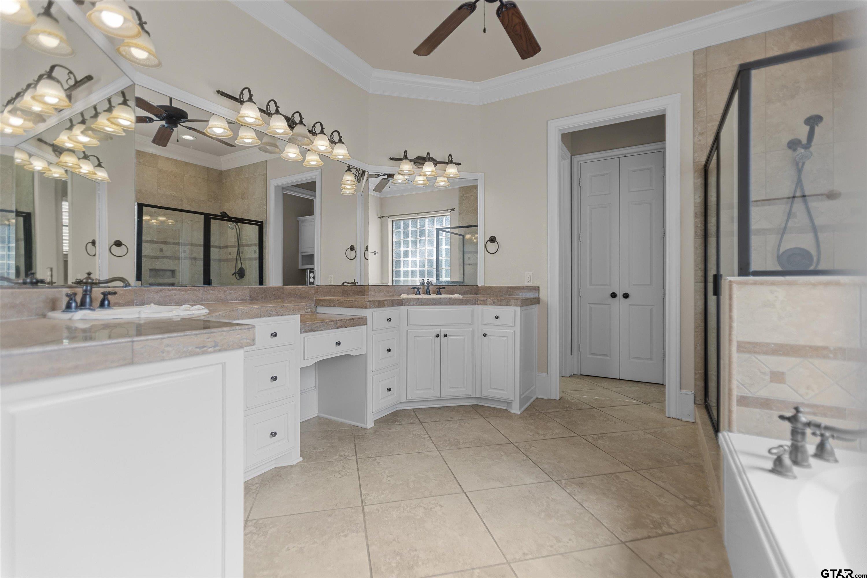 2312 Pinehurst Street Tyler, TX 75703 - Photo 24 of 43 a spacious bathroom with a granite countertop sink a mirror and a shower