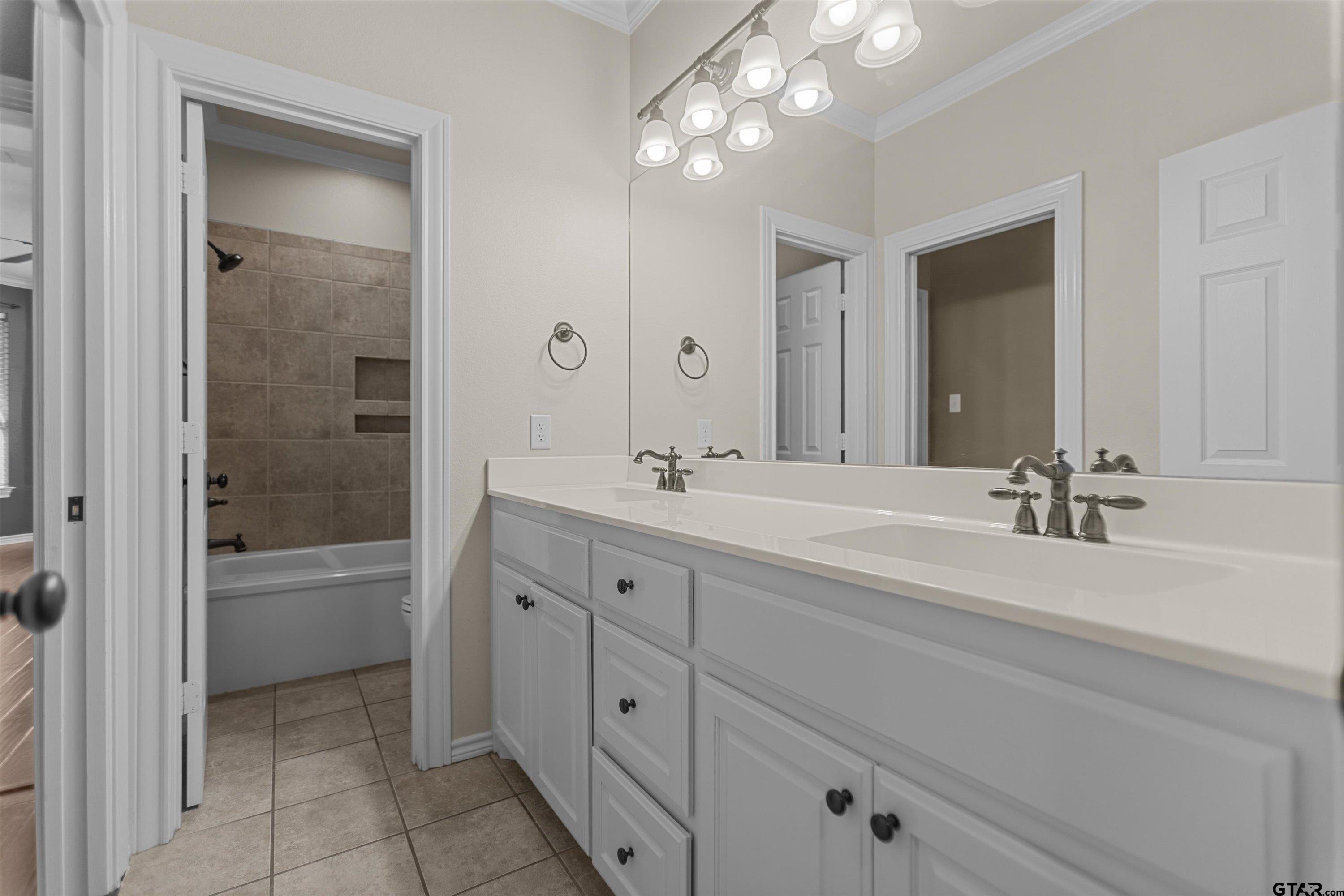 2312 Pinehurst Street Tyler, TX 75703 - Photo 31 of 43 a spacious bathroom with a bathtub shower sink double and mirror