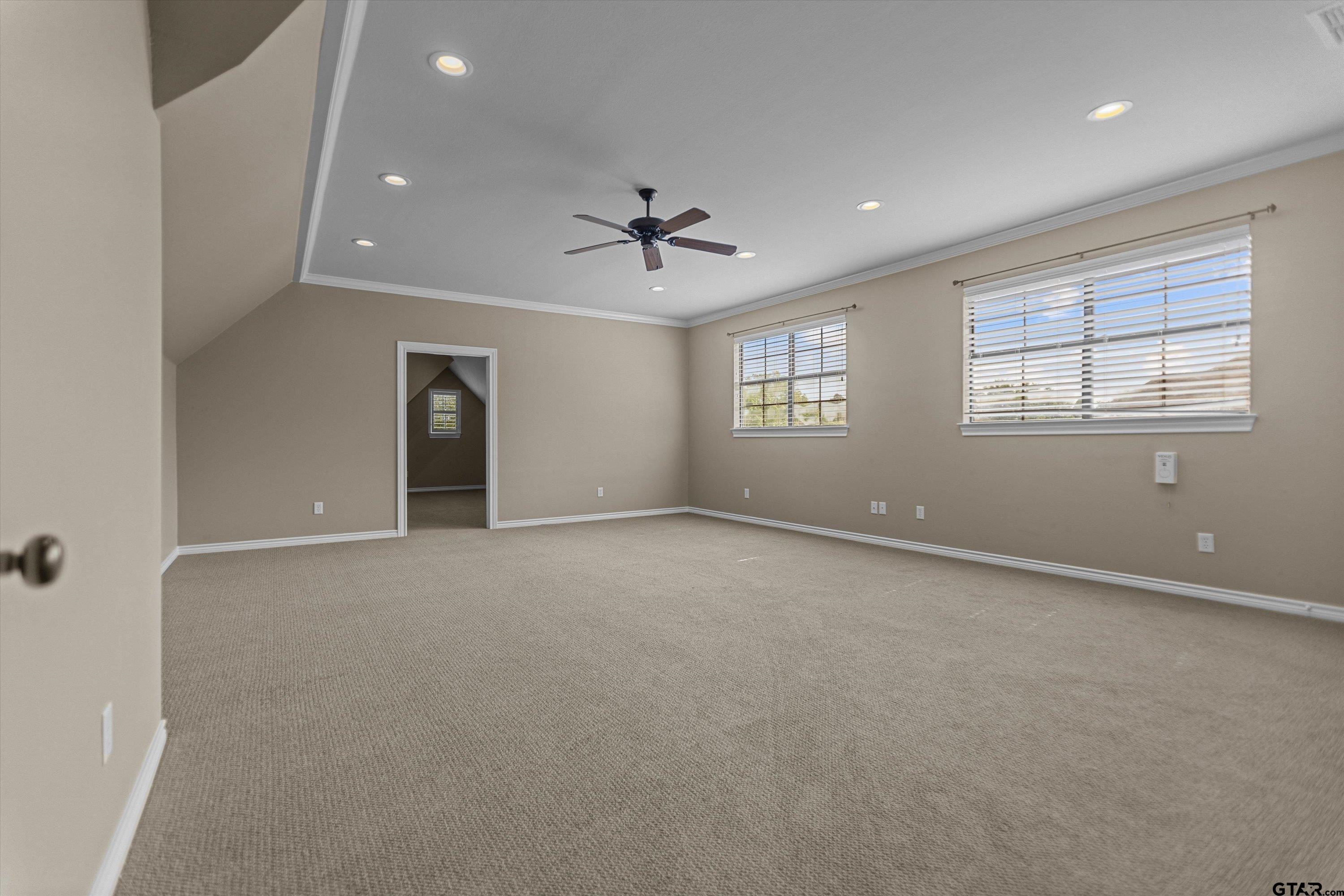 2312 Pinehurst Street Tyler, TX 75703 - Photo 32 of 43 an empty room with chandelier fan and windows
