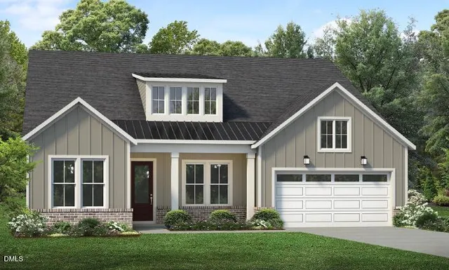 a front view of a house with a garden and plants