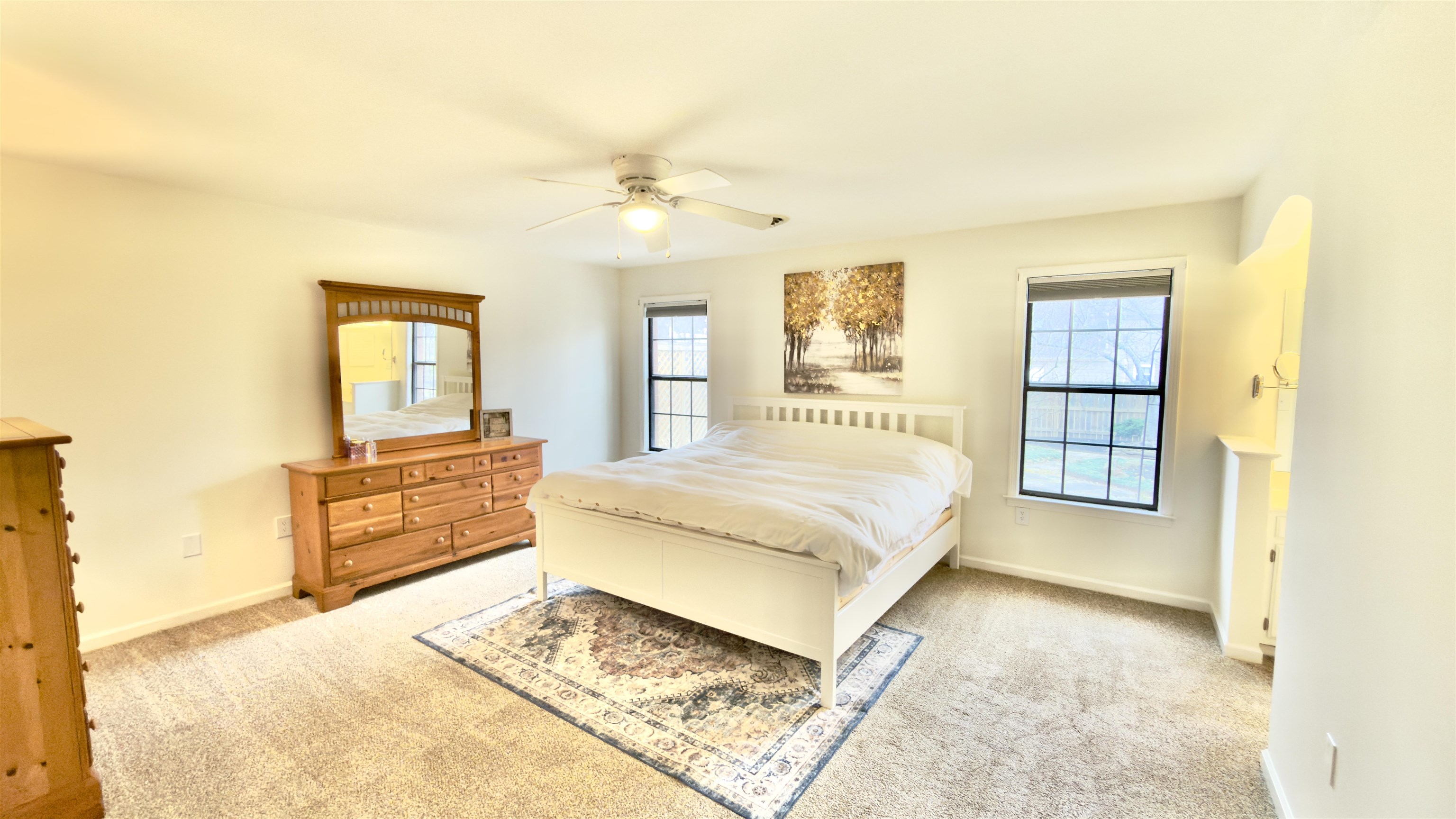 396 North Main Street Collierville, TN 38017 - Photo 11 of 23 a spacious bedroom with a large bed a chandelier and dresser