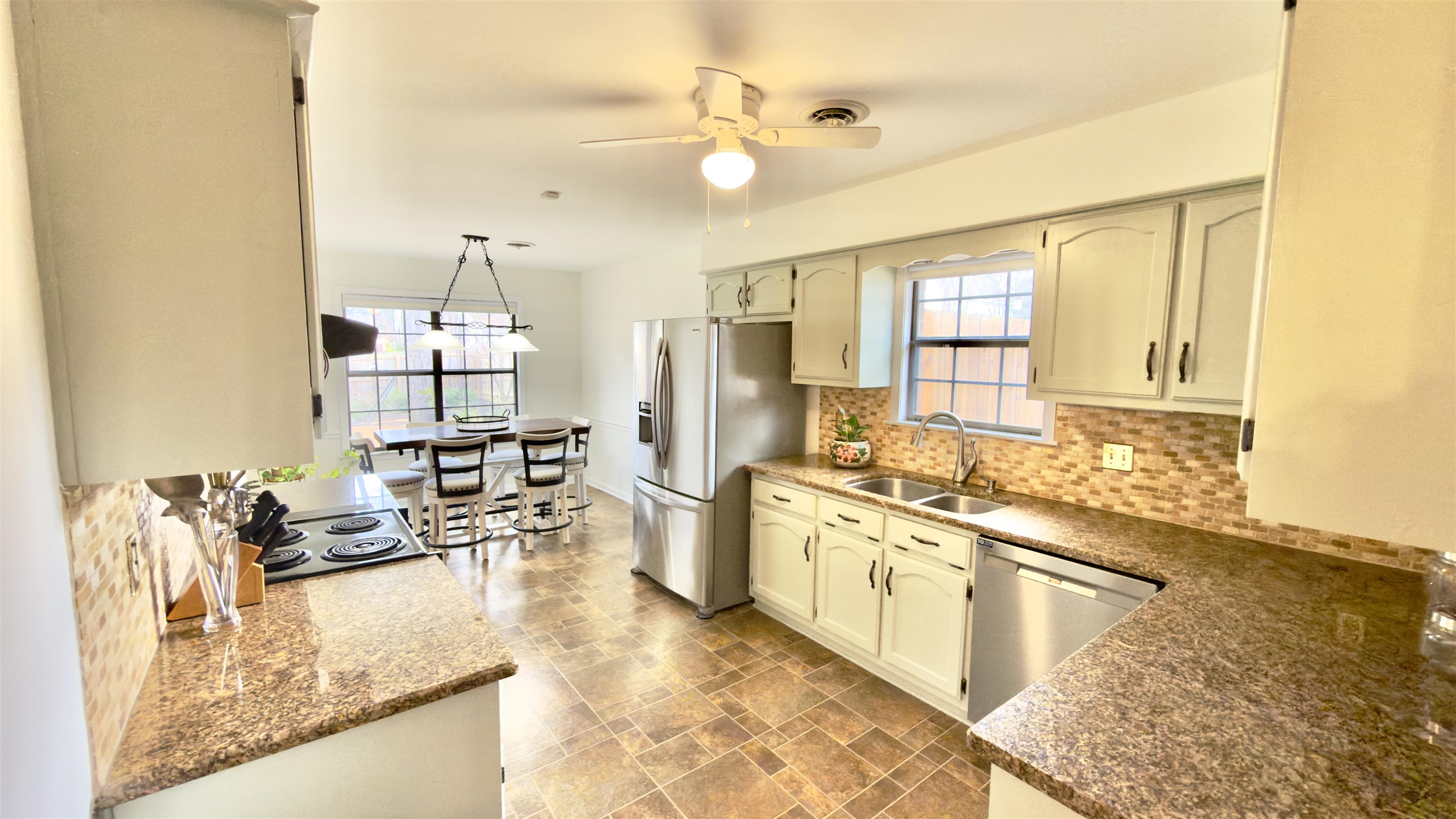 396 North Main Street Collierville, TN 38017 - Photo 7 of 23 a kitchen with stainless steel appliances granite countertop a sink stove and refrigerator