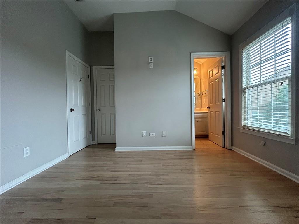 1207 Discover Green Lane, Unit 20 Mableton, GA 30126 - Photo 19 of 29 a view of an empty room with wooden floor and a window
