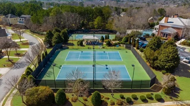 an aerial view of a multi story building with a yard