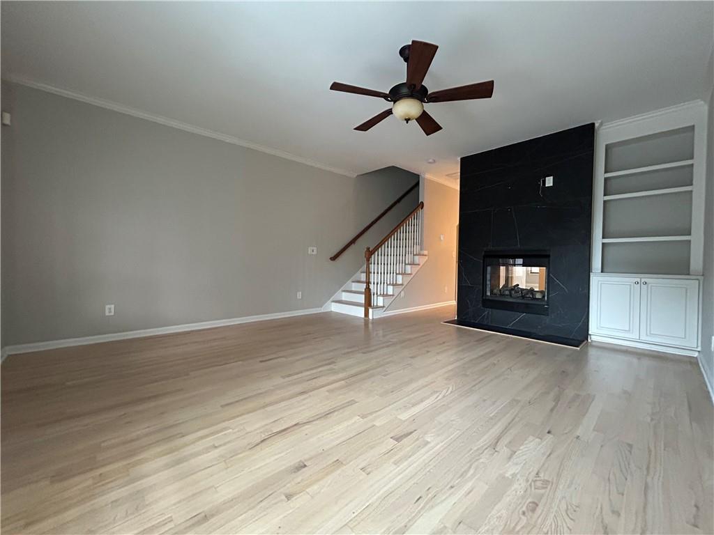 1207 Discover Green Lane, Unit 20 Mableton, GA 30126 - Photo 4 of 29 a view of an empty room with wooden floor and a ceiling fan