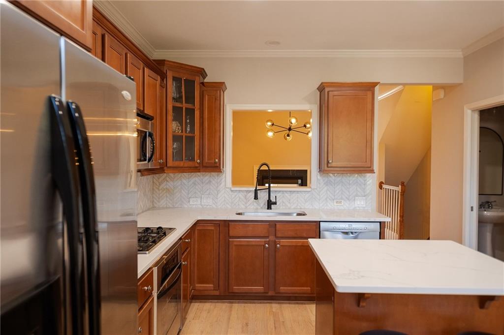 1207 Discover Green Lane, Unit 20 Mableton, GA 30126 - Photo 7 of 29 a kitchen with kitchen island a counter top space a sink a refrigerator and a stove